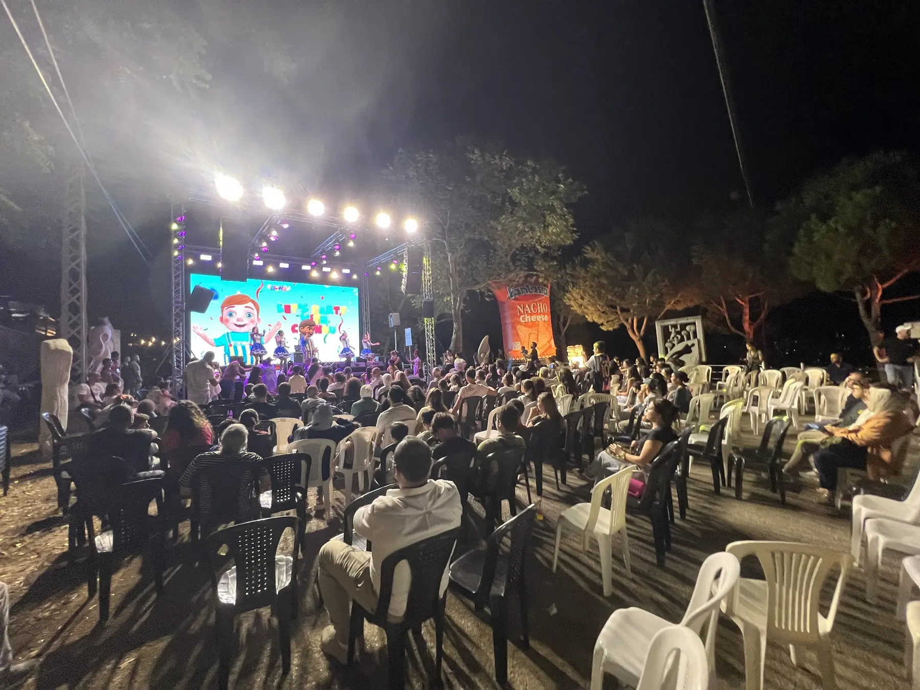 Families enjoying a large outdoor Calinou event