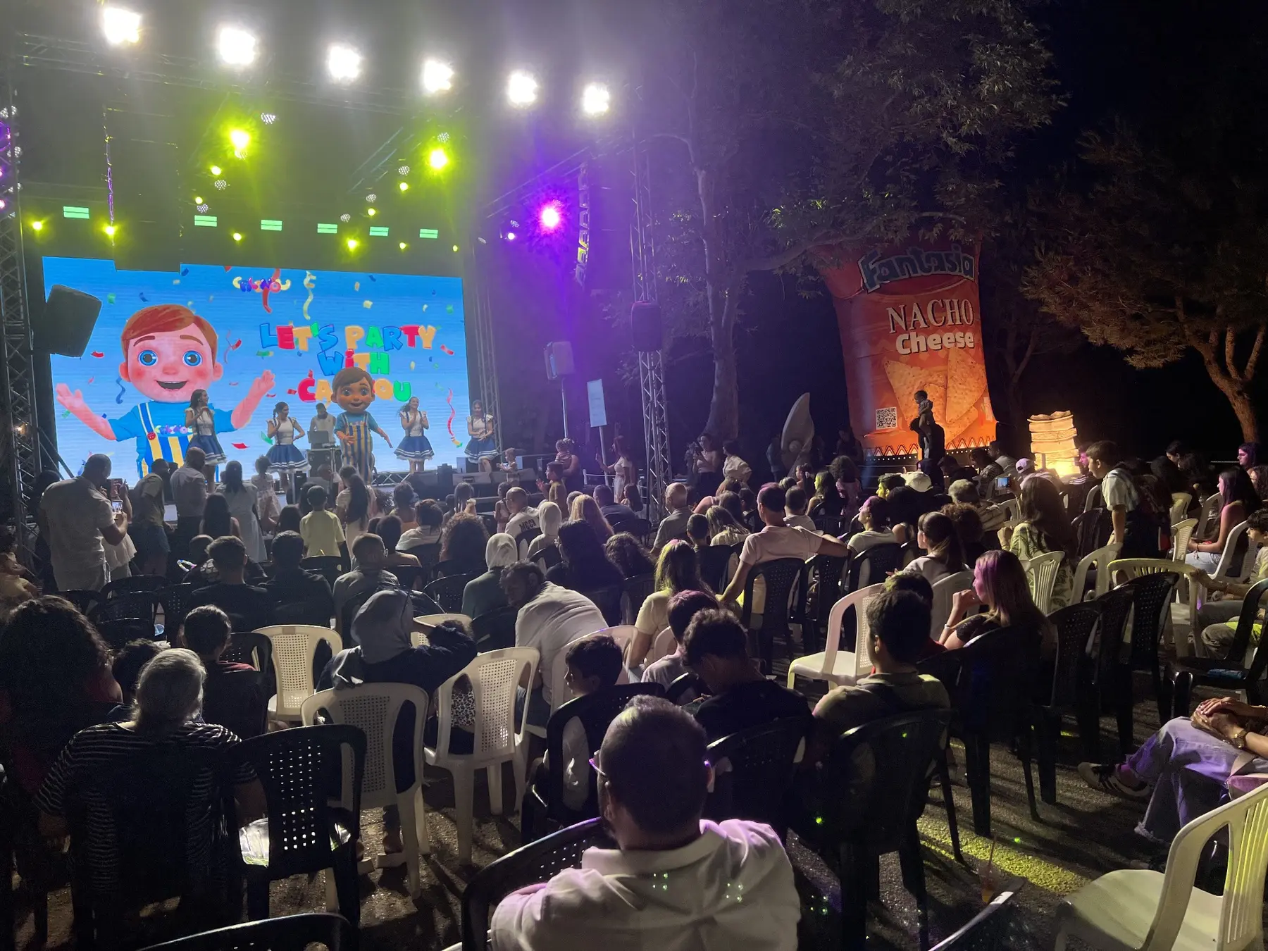 Families watching Calinou perform at an outdoor event